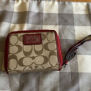 Red and tan coach wallet with wrist strap